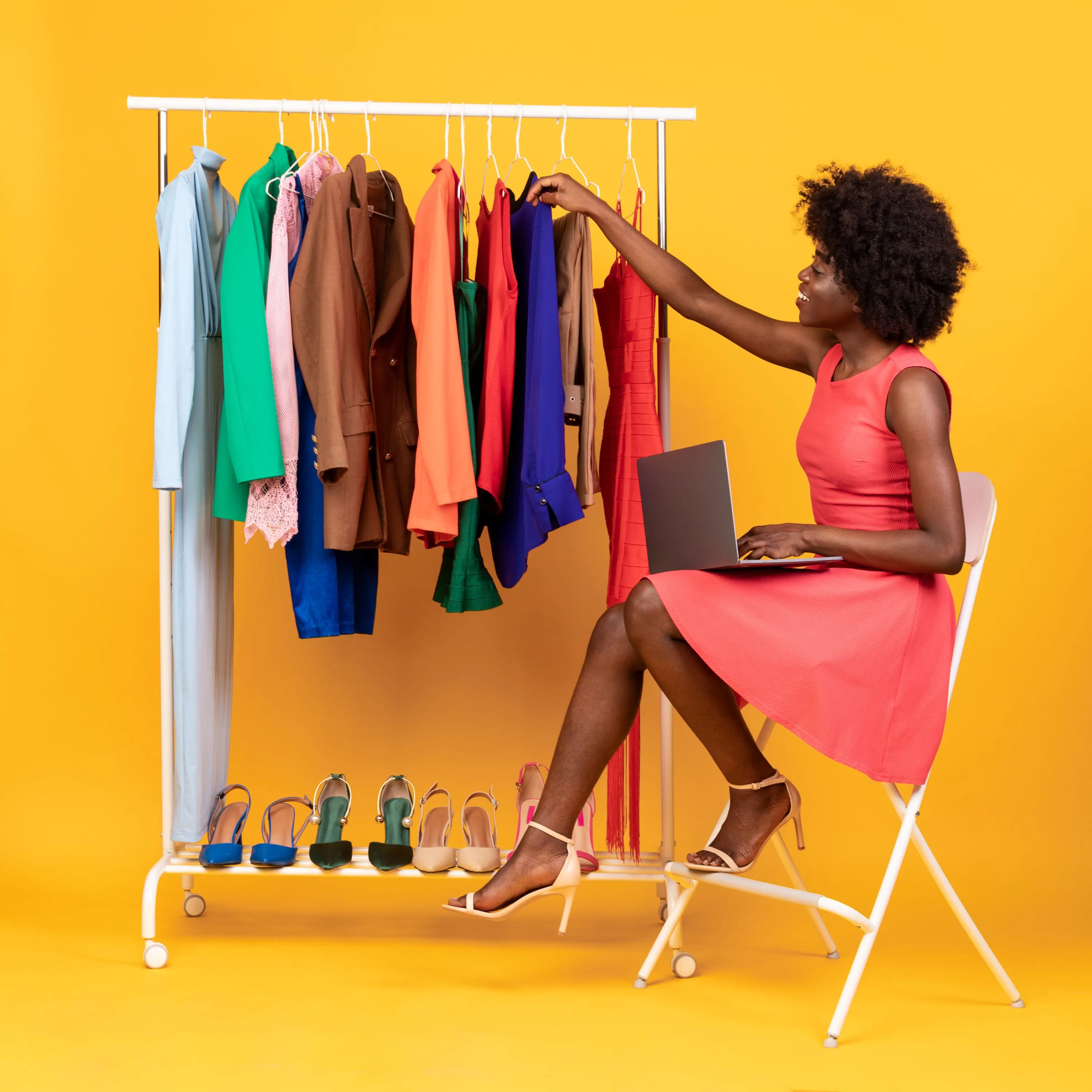 woman chosing clothes off a rail