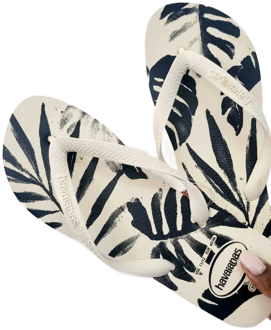 white slippers with black monsterra leaves